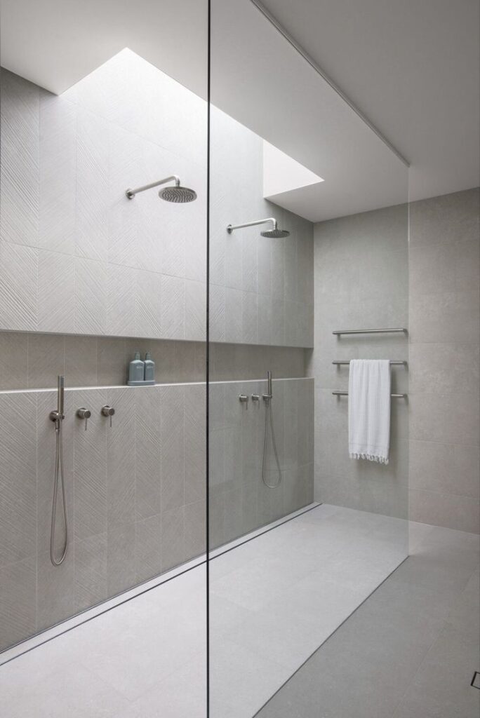 Minimal spa shower with bench and carefully controlled lighting