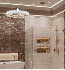 White tiled shower with glass and chrome fixtures